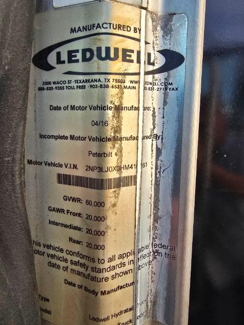 Label on a vehicle component showing 'MANUFACTURED BY LEDWE... L E D W E L ...' with Dot text: Date of Motor Vehicle Manufacture 04/16, Motor Vehicle V.I.N. 2NP3LJ0X... GVWR: 60,000 GAWR Front: 20,000 Intermediate: 20,000 Rear: 20,000