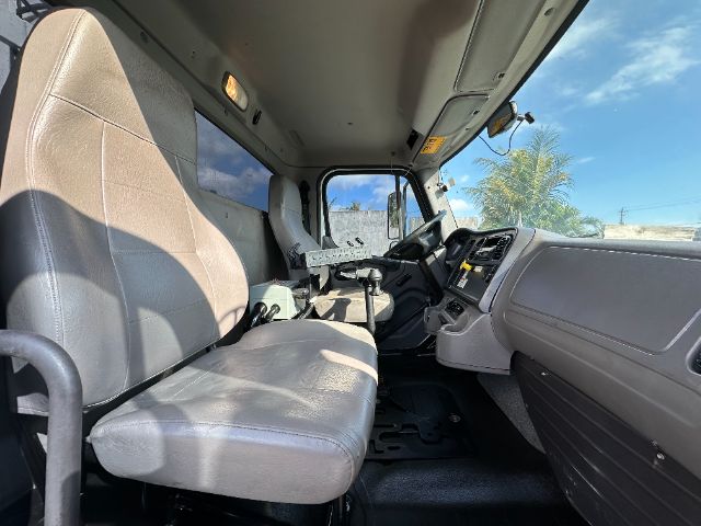 Cab interior of a 2016 Freightliner 108SD vacuum truck showing driver seat, steering wheel, dashboard, and center console.