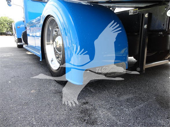 Front section of a blue Peterbilt 337 truck showing front fender and wheel well with stock image watermark of a flying eagle.