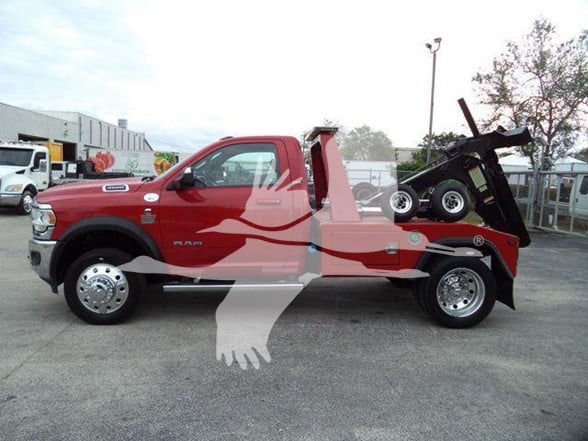 2021 Ram 4500 SLT tow truck side view with red cab and black dump bed, wheel base visible.