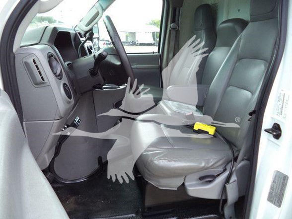Ford E-450 passenger area showing front seats and dashboard in a used truck.