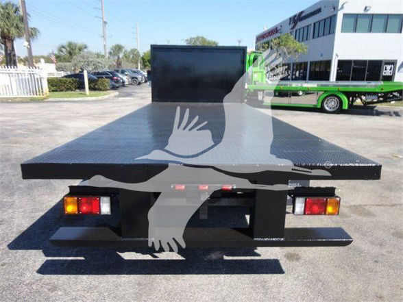 Flatbed tow truck bed rear view with taillights and a black platform.