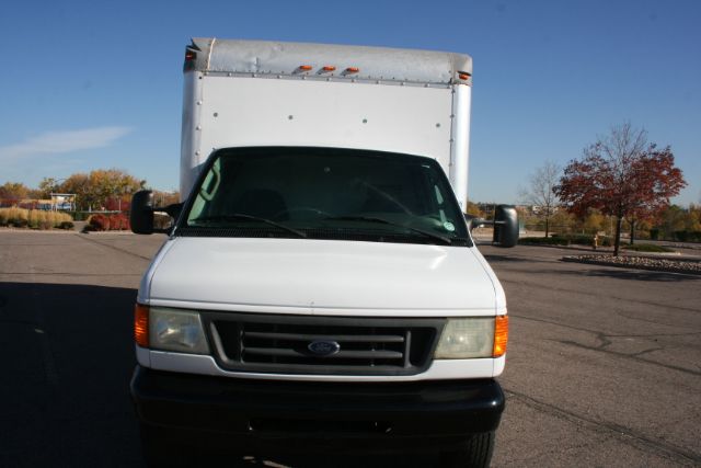 Box truck front view showing Ford emblem on grille and large cargo box behind cab.