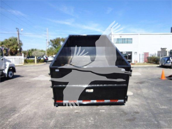 Isuzu NRR truck bed/dump area visible from rear with black paint and reflective red/white rear bumper lights.