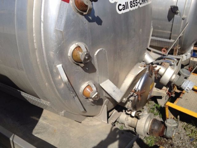 Progress VA72 vacuum tank truck rear end showing circular ports and pipe fittings on cylindrical tank.