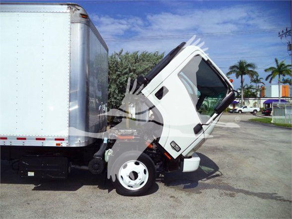 Isuzu NRR box truck with cab tilted up at a loading site.
