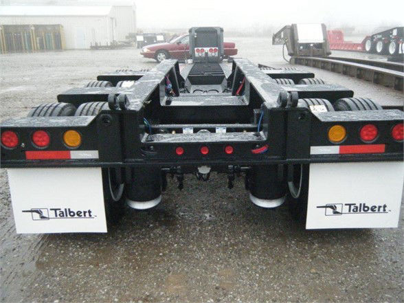 Talbert 55SA flat level deck HRG trailer rear view showing mud flaps with Talbert logo and multiple red/amber lights.