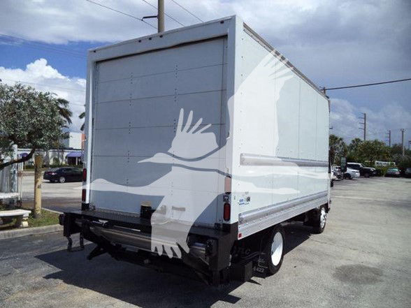 Isuzu NPR-HD box truck rear view showing plain cargo box with white wheels and rear bumper. No legible labels visible on the panel.