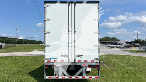 Rear view of a white Vanguard Vip Sheet & Post trailer with double rear doors, reflective tape, and Vanguard logo on lower left door.