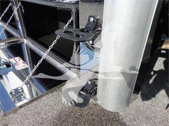 Tow truck hitch and chain setup on a new 2022 International MV equipment trailer, showing metal framing, a ramp hinge, and caster wheel.