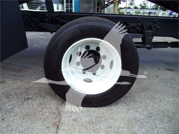 Wheel and tire on a Ford F650 SD grapple truck chassis showing white steel rim and black tire.