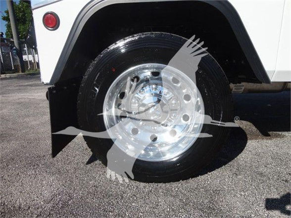 Wheel and tire of a white Ram 4500 truck with polished aluminum rim