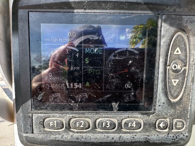 In-service International 7500 vacuum truck dashboard display with gauges and multiple readouts; control buttons F1-F4 and OK arrows visible.