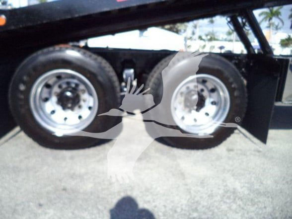 Freightliner heavy truck undercarriage showing dual rear axles with rims and tires. watermark obscures some details.