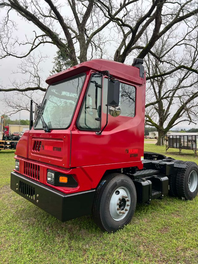 Kalmar Ottawa T2 yard truck cab front-left view showing red cab, black bumper, and dual rear wheels. Visible text includes Kalmar Ottawa on door and grille area.