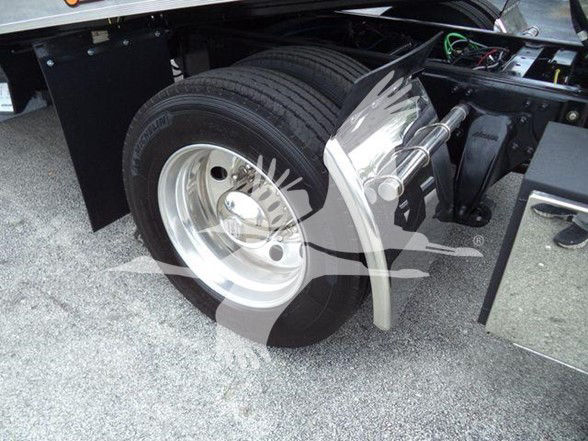Freightliner M2 106 wheel and front suspension area showing large steel wheel and suspension components.