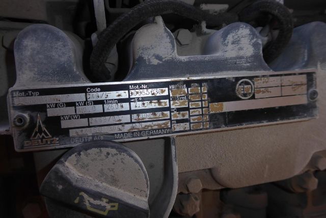 Tractor-attachment plate on Grove T60 boom crane showing model and serial information and wiring harnesses.