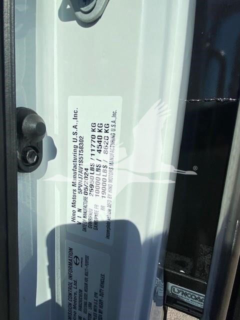 Label on door jamb with vehicle specifications for Hino Motors Manufacturing U.S.A., Inc., including gross vehicle weight and axle ratings.