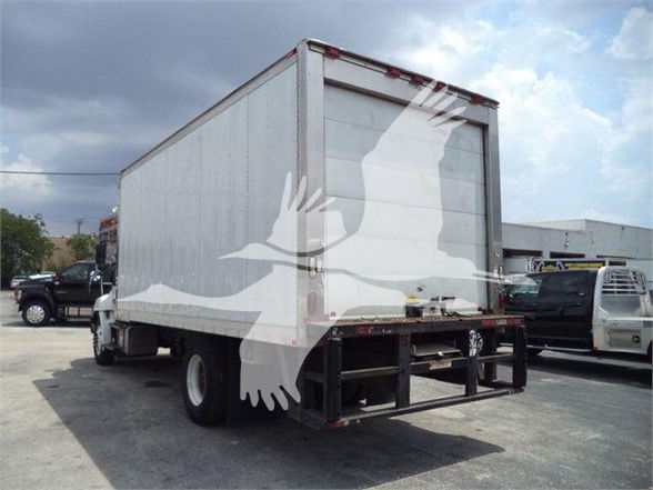 Rear and side view of a white refrigerated box truck with liftgate at rear, vendor logo watermark across image.