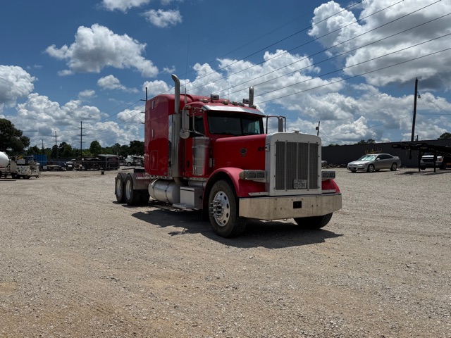 Peterbilt 379 conventional sleeper truck in red with chrome grille, parked on gravel lot, stock number R5.