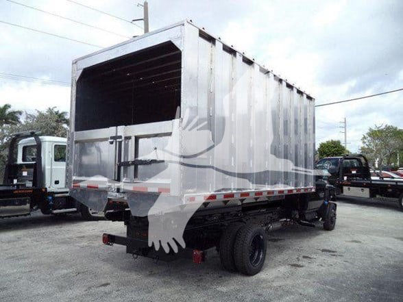 Truck bed seen from rear-left showing a gray dump/haul bed on a Silverado 6500HD chassis with dual rear wheels.