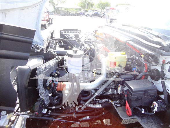 Chevrolet Silverado 5500HD engine bay showing various components including coolant reservoir, power steering area, and electrical harnesses.