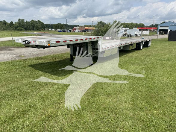 2018 Reitnouer Drop M I S E R trailer with ras. Side view showing elongated flatbed with drop deck and expansion hinge, trailer tires visible.
