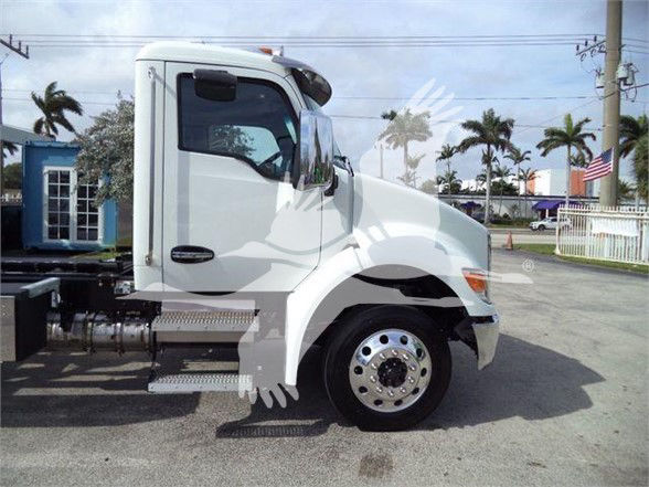 Kenworth T280 front-side view showing white cab and wheel, chassis, and side steps.