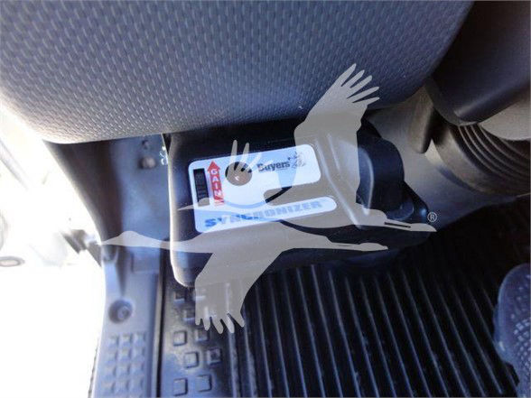 Isuzu NRR interior dash area with a label showing 'Air' and other smaller text on a sticker near the pedal; focuses on a black box/handle area.