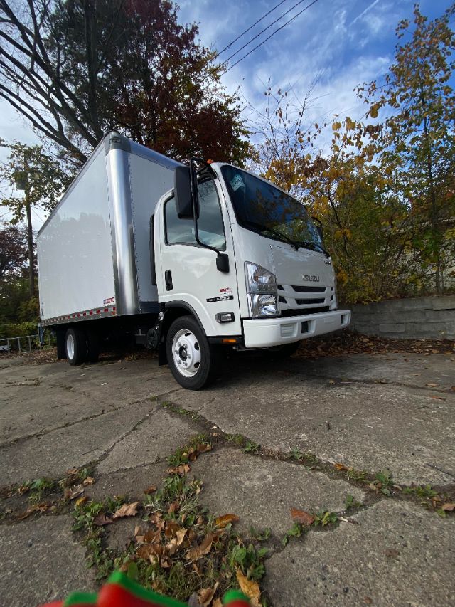 Isuzu NRR gas cab chassis box truck showing side and front view with white cab and large box trailer.