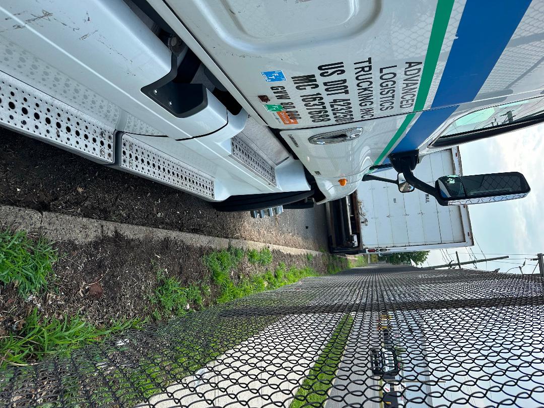 Truck side of a 2011 Freightliner Cascadia conventional sleeper showing steps, mirrors, and door stickers with data labels.