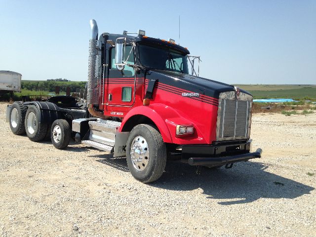 Kenworth T800 conventional daycab truck in red with chrome sleeper tower and dual rear axles.