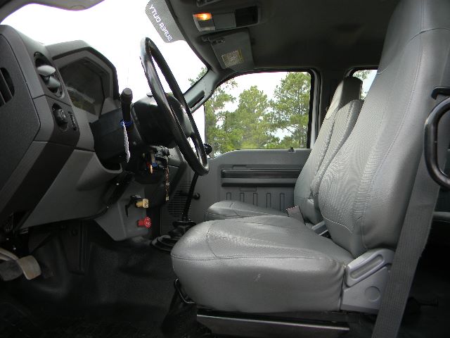 Ford F-750 Super Duty cab interior showing driver seat and passenger seat with steering wheel and dashboard visible.