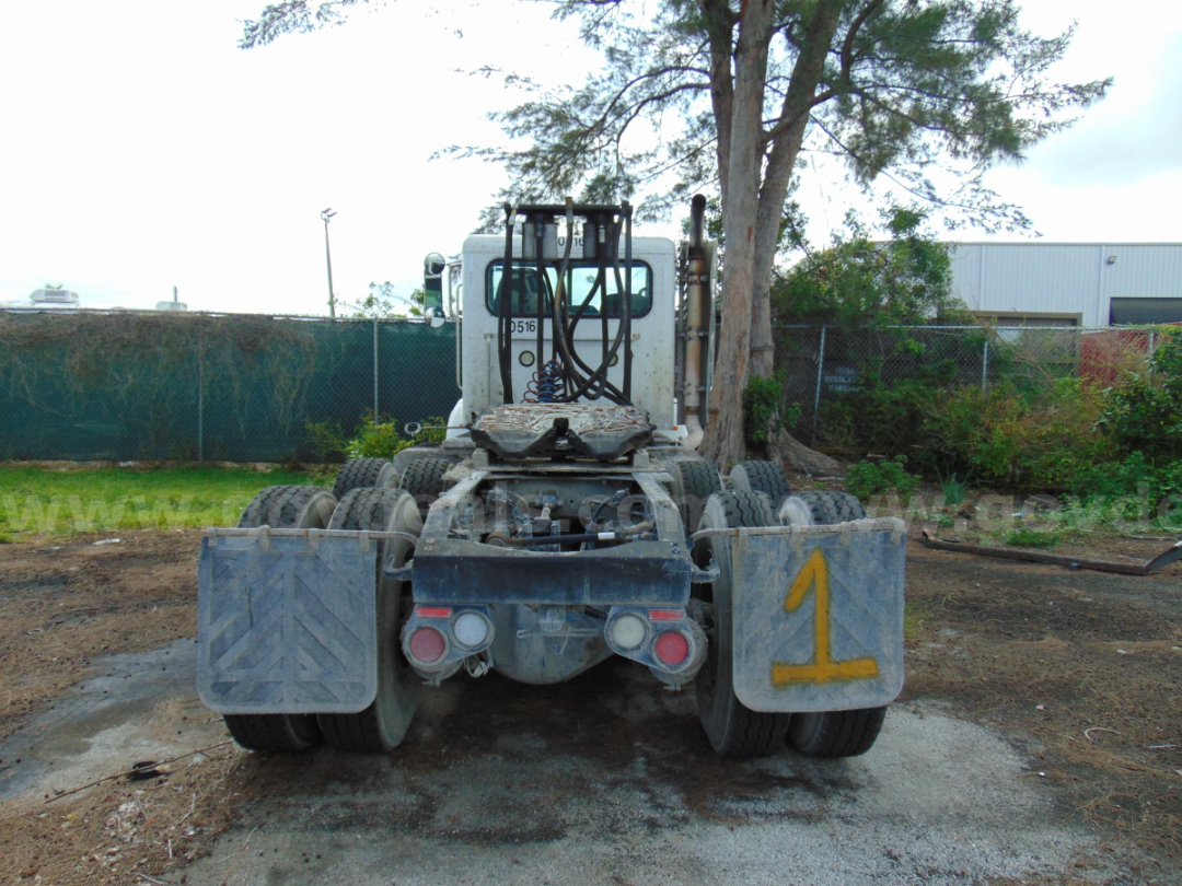 Peterbilt 365 cab and chassis rear view showing dual rear axles, mud flaps, and yellow '1' marking.
