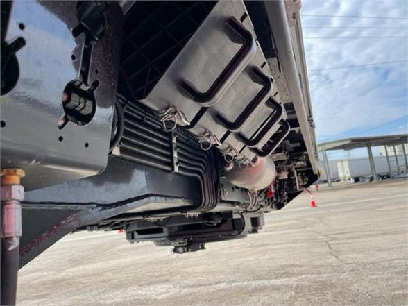 Trailer undercarriage showing frame and underside components with wiring looms and a low-angle view of the side rails.