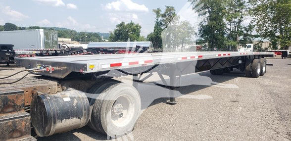 Transcraft 2016 Combo Flatbed trailer showing side rails, dual rear wheels, and tag area.