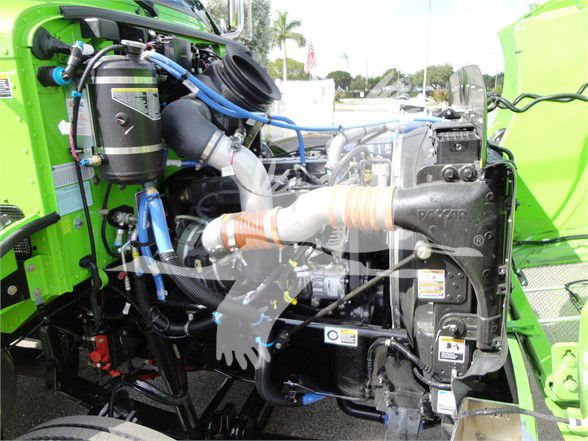 Peterbilt 337 engine bay showing turbocharged motor with hoses and COLD/BLUE wiring near radiator and coolant reservoir.