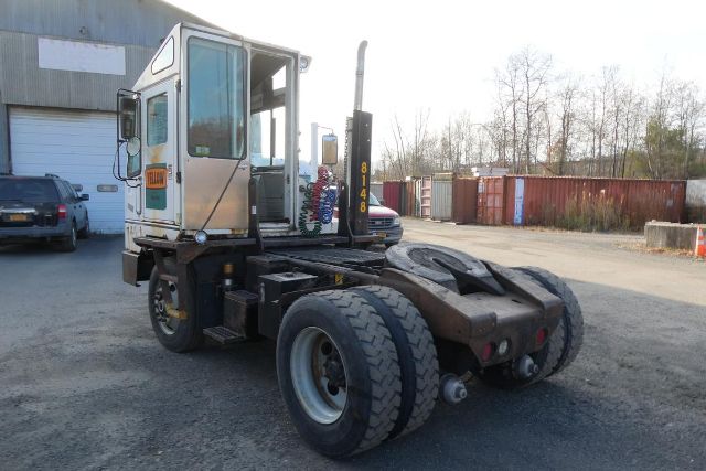 2001 Ottawa 30 yard truck chassis showing side cab and rear wheel assembly with hydraulic lines and fifth wheel