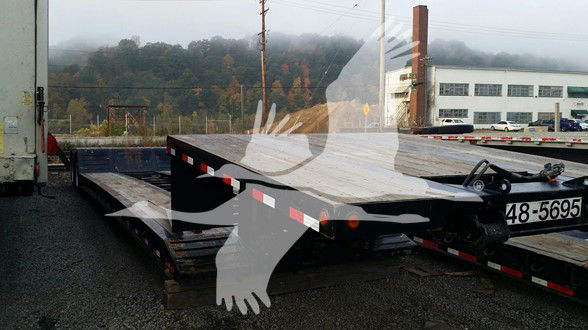 Lowboy trailer with Kalyn Siebert branding and stock number plate 48-5695 visible on the side; flatbed with metal deck and tie-down points.