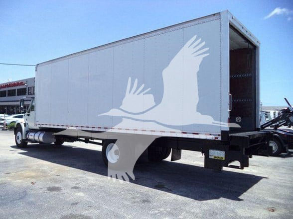 Box truck rear and side view showing cargo box, open rear doors, International DURASTAR 4300 likely chassis cab with box body.