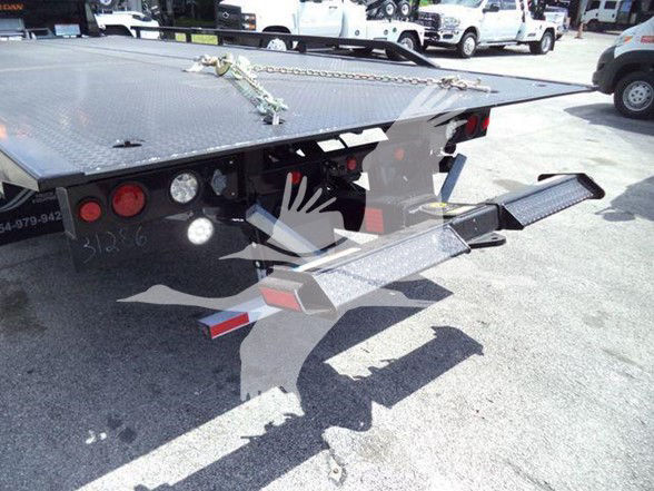 Tow truck flatbed rear showing loading ramps and tail lights on a 2024 Ram 5500 SLT listing.