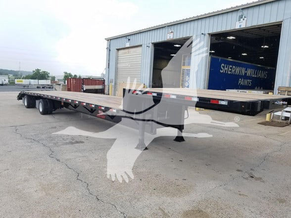 Beavertail trailer with flatbed and expandable rear section at a service yard showing VIN 7KYDF5321TED45504 and stock TED45504.