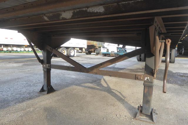 Trailer landing gear and cross braces under a Great Dane trailer, showing lower frame and supports.