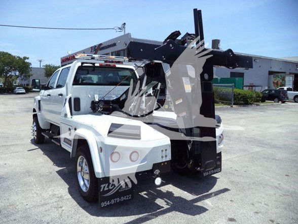 Tow truck with crane/boom on white cab and chassis, side view showing lifting apparatus.