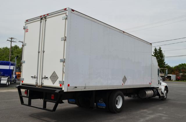 Kenworth T370 box truck rear and side view with a large white cargo box, dual rear doors, bumper guards, and diamond placards on doors.