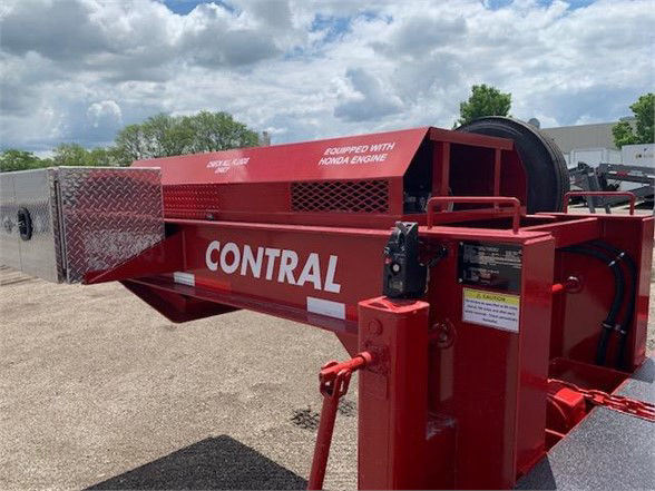 Contrail drop deck container delivery trailer with red frame and black wheel cover showing CONTRAL branding and safety decals.