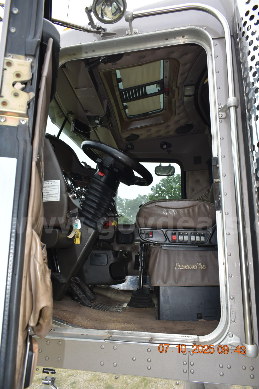 Cab and chassis truck interior showing steering wheel, dashboard, and driver seat in Kenworth W900 cabin.