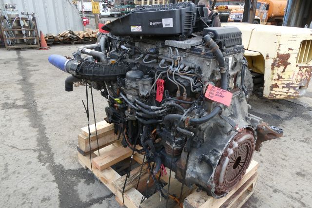 Detroit DD15 engine core showing detailed engine with hoses, wires, and labels on a pallet.