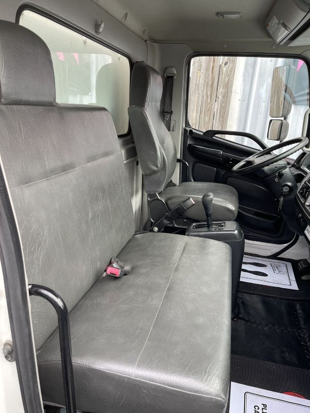 Interior of 2017 Hino 268 box truck cab showing front bench seat, driver's seat, steering wheel, and gear shifter.