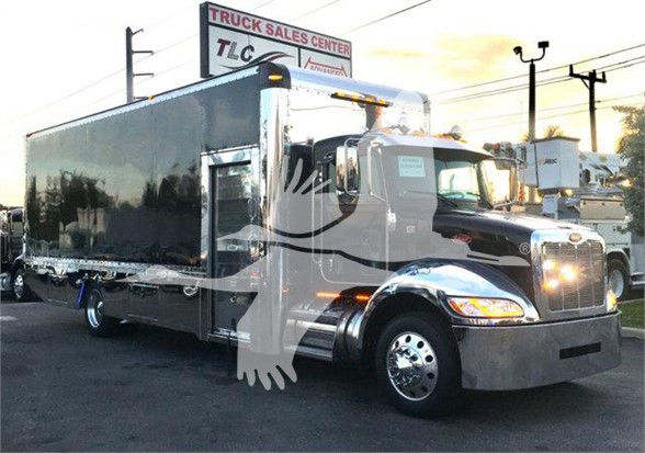 Peterbilt 337 tow truck side view showing large rectangular cargo box and chrome wheels.